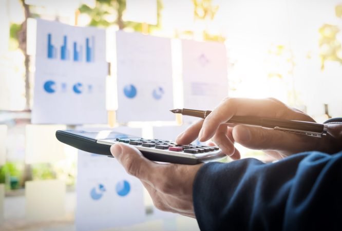Business finance man calculating budget numbers, Invoices and financial adviser working.