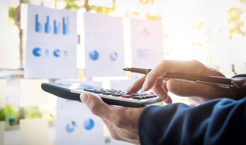 Business finance man calculating budget numbers, Invoices and financial adviser working.